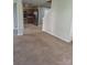 Open-concept living room flows into a kitchen with stainless steel appliances and wooden cabinetry at 7113 Sycamore Grove Ct, Charlotte, NC 28227