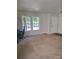 Spacious living room featuring plush carpet and large windows that offer plenty of natural light at 7113 Sycamore Grove Ct, Charlotte, NC 28227