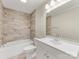 Updated bathroom features modern tile, shower-tub combo, and vanity sink at 721 Broad St, Kannapolis, NC 28081