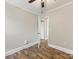 Bedroom with hardwood flooring and white trim with an open door at 721 Broad St, Kannapolis, NC 28081