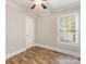 This bedroom has hard wood floors, blinds, and a ceiling fan at 721 Broad St, Kannapolis, NC 28081