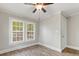 Bright bedroom features hardwood flooring, ceiling fan, and a double window at 721 Broad St, Kannapolis, NC 28081