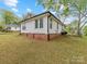 Exterior shows the side of the house with brick trim and siding at 721 Broad St, Kannapolis, NC 28081