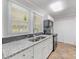 Modern kitchen with granite countertops, white cabinetry, and stainless steel appliances at 721 Broad St, Kannapolis, NC 28081