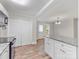 Open kitchen with white cabinetry, island with granite countertops, and stainless steel appliances at 721 Broad St, Kannapolis, NC 28081