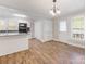 Bright, airy kitchen and dining area boasts modern appliances, granite counters, and durable vinyl flooring at 721 Broad St, Kannapolis, NC 28081