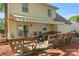 Backyard features a wooden deck, patio seating, and retractable awning at 7220 Spring Morning Ln, Charlotte, NC 28227