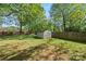 Well-maintained backyard with a storage shed and a fence, offering privacy and convenience at 7220 Spring Morning Ln, Charlotte, NC 28227