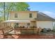 Inviting backyard with a wooden deck, patio furniture and trees at 7220 Spring Morning Ln, Charlotte, NC 28227
