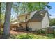 Spacious backyard with a deck, patio furniture, and shade trees at 7220 Spring Morning Ln, Charlotte, NC 28227