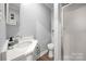 Bright bathroom featuring modern fixtures, a vanity with storage, and a shower with clear glass doors at 7220 Spring Morning Ln, Charlotte, NC 28227