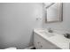 Neat half bathroom with white vanity, countertop, modern fixtures and a decorative seashell accent at 7220 Spring Morning Ln, Charlotte, NC 28227