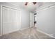 This bedroom has a double door closet and neutral wall color at 7220 Spring Morning Ln, Charlotte, NC 28227