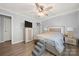 This bedroom features a bed, lamps and a ceiling fan at 7220 Spring Morning Ln, Charlotte, NC 28227