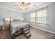 This bedroom features a bed, lamps and a ceiling fan at 7220 Spring Morning Ln, Charlotte, NC 28227