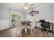 Cozy dining area features a round wooden table, comfortable seating, and a sliding glass door leading to the outside at 7220 Spring Morning Ln, Charlotte, NC 28227