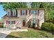 Charming two-story home features dormer windows, red shutters, brick steps, and a well-manicured lawn at 7220 Spring Morning Ln, Charlotte, NC 28227