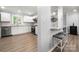 Modern kitchen features white cabinets, stainless steel appliances, and a stylish breakfast bar with seating at 7220 Spring Morning Ln, Charlotte, NC 28227