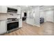 Updated kitchen offers white cabinetry, modern appliances, and a seamless flow into the adjacent living spaces at 7220 Spring Morning Ln, Charlotte, NC 28227