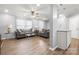 Inviting living room with hardwood floors, comfortable sofas, and large windows offering natural light at 7220 Spring Morning Ln, Charlotte, NC 28227