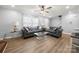 Bright and airy living room with hardwood floors, plush gray sofas, and contemporary glass coffee tables at 7220 Spring Morning Ln, Charlotte, NC 28227