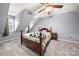 Cozy bedroom featuring sloped ceilings, a comfortable bed, soft carpet, and a bright window at 7220 Spring Morning Ln, Charlotte, NC 28227