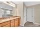 Bathroom featuring double sinks with granite countertop and a large mirror at 7362 Waterwheel Sw St # 280, Concord, NC 28025