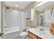 Bright bathroom featuring a shower-tub combination, a mirrored vanity with storage, and neutral-toned walls at 7362 Waterwheel Sw St # 280, Concord, NC 28025