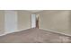 Spacious bedroom with neutral walls and carpet flooring at 7362 Waterwheel Sw St # 280, Concord, NC 28025