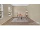 Cozy bedroom featuring neutral carpeting and a stylish workspace with a desk, chair, and full-length mirror at 7362 Waterwheel Sw St # 280, Concord, NC 28025