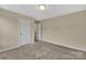 Neutral carpeted bedroom with standard closet and single light fixture at 7362 Waterwheel Sw St # 280, Concord, NC 28025