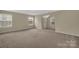 Large bedroom with neutral walls, carpet flooring, and lots of light at 7362 Waterwheel Sw St # 280, Concord, NC 28025