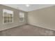 Bright bedroom with neutral walls, carpet flooring, and dual windows at 7362 Waterwheel Sw St # 280, Concord, NC 28025