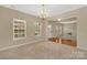 Open-concept dining area connected to the living room and entryway, featuring a chandelier and natural light at 7362 Waterwheel Sw St # 280, Concord, NC 28025