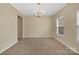 Spacious dining room featuring a chandelier and neutral carpet, offering an elegant space for meals at 7362 Waterwheel Sw St # 280, Concord, NC 28025