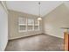 Bright dining area with tile floors, large windows and modern hanging light fixture at 7362 Waterwheel Sw St # 280, Concord, NC 28025
