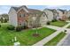 Beautifully landscaped front yard with lush green grass and a healthy tree, enhancing the home's curb appeal at 7362 Waterwheel Sw St # 280, Concord, NC 28025