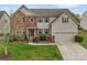 Charming two-story home featuring a brick facade, well-maintained lawn, and an attached two-car garage at 7362 Waterwheel Sw St # 280, Concord, NC 28025