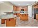 Kitchen with granite counters, island, stainless steel appliances, and wood cabinets at 7362 Waterwheel Sw St # 280, Concord, NC 28025