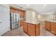 Well-lit kitchen featuring stainless steel refrigerator and granite island and counters at 7362 Waterwheel Sw St # 280, Concord, NC 28025