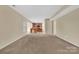 Large living room featuring neutral carpeting and a view into the kitchen at 7362 Waterwheel Sw St # 280, Concord, NC 28025