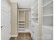 Organized walk-in closet with custom shelving and drawers for ample storage at 7362 Waterwheel Sw St # 280, Concord, NC 28025