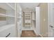 Bright walk-in closet with custom shelving and drawers for ample storage at 7362 Waterwheel Sw St # 280, Concord, NC 28025