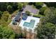 Aerial view of the community pool area with lounge chairs and play area surrounded by mature trees at 739 Ivy Trail Way, Fort Mill, SC 29715