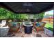 Backyard patio seating area featuring comfortable wicker furniture around a fire pit and stone base at 739 Ivy Trail Way, Fort Mill, SC 29715