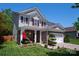 Charming two-story home with stone accents, covered porch, red shutters and manicured yard at 739 Ivy Trail Way, Fort Mill, SC 29715