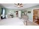 Inviting main bedroom with a comfortable armchair, well-lit vanity, and a neutral color palette at 739 Ivy Trail Way, Fort Mill, SC 29715