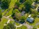 An aerial view of a landscaped property featuring a charming house, lush trees, and well-maintained lawns at 821 Mark St, Belmont, NC 28012