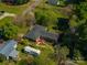 Aerial view of a brick home with a spacious yard, deck, and mature trees in a quiet neighborhood at 821 Mark St, Belmont, NC 28012