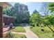 A walkway through a manicured lawn leads to a spacious, private backyard garden at 821 Mark St, Belmont, NC 28012
